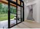 Hallway with tile floors leading to staircase and outdoor view at 836 Bailey Woods Rd, Dacula, GA 30019