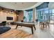Resident amenity room with billiards table, lounge seating and a wall of floor to ceiling windows at 1080 Peachtree Ne St # 1812, Atlanta, GA 30309