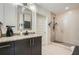 Neutral toned bathroom with a granite vanity, modern fixtures, and tiled shower at 1080 Peachtree Ne St # 1812, Atlanta, GA 30309