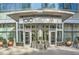 Welcoming entrance to 1010 Midtown, showcasing modern architecture, glass doors and manicured greenery at 1080 Peachtree Ne St # 1812, Atlanta, GA 30309
