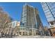 Striking exterior view of 1010 Midtown, an upscale high-rise condominium with balconies and vibrant street-level retail at 1080 Peachtree Ne St # 1812, Atlanta, GA 30309
