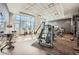 Well-equipped gym featuring cardio machines and weightlifting equipment with large windows and a patterned ceiling at 1080 Peachtree Ne St # 1812, Atlanta, GA 30309