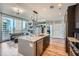 Modern kitchen with stainless steel appliances and granite countertops, open to a city view at 1080 Peachtree Ne St # 1812, Atlanta, GA 30309