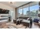 Inviting living room with floor-to-ceiling windows showcasing the city skyline, gray sofa at 1080 Peachtree Ne St # 1812, Atlanta, GA 30309