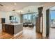 Open-concept living space with kitchen island, modern furnishings, hardwood floors, and cityscape views at 1080 Peachtree Ne St # 1812, Atlanta, GA 30309