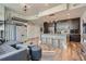 Modern open-concept living area with kitchen island seating, sleek furnishings, and hardwood floors at 1080 Peachtree Ne St # 1812, Atlanta, GA 30309