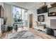 Bright home office with large windows overlooking the city, modern décor, and wood flooring at 1080 Peachtree Ne St # 1812, Atlanta, GA 30309