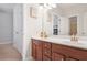Bathroom boasts dual sinks, a wood vanity with a white countertop and access to another room at 145 Treeside Ter, Fayetteville, GA 30214
