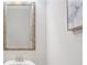 Powder room featuring a framed mirror and a modern faucet on a pedestal sink at 145 Treeside Ter, Fayetteville, GA 30214
