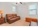 Spacious bedroom with a brown leather couch, wood furniture, and lots of light at 145 Treeside Ter, Fayetteville, GA 30214