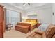 Relaxing Primary bedroom with a tray ceiling, wood furniture, and natural light at 145 Treeside Ter, Fayetteville, GA 30214