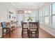 Bright dining area with wainscoting, natural light, and access to a patio at 145 Treeside Ter, Fayetteville, GA 30214