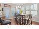 Sun-filled dining area features a modern chandelier and access to outdoor space at 145 Treeside Ter, Fayetteville, GA 30214
