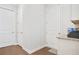Hallway with hardwood floors and neutral paint, with access to two doors at 145 Treeside Ter, Fayetteville, GA 30214
