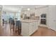 Spacious kitchen with stainless steel appliances, a center island with bar stools and bright lighting at 145 Treeside Ter, Fayetteville, GA 30214