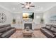 Bright living room with a fireplace, built-in cabinets, and a ceiling fan for added comfort at 145 Treeside Ter, Fayetteville, GA 30214