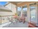 Cozy patio with comfortable rocking chairs and a table and chairs, perfect for outdoor relaxation at 145 Treeside Ter, Fayetteville, GA 30214
