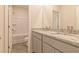 Bathroom featuring double sinks with granite countertops, gray cabinets, and a shower/tub combination at 246 Orwell Dr, Social Circle, GA 30025