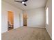 Spacious bedroom with neutral carpet, ceiling fan, a window letting in natural light, and two access doors at 246 Orwell Dr, Social Circle, GA 30025