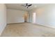 Spacious bedroom with plush carpeting, ceiling fan, and ample natural light from the doors at 246 Orwell Dr, Social Circle, GA 30025