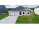 Charming single-story home showcasing a well-manicured lawn and a two-car garage at 246 Orwell Dr, Social Circle, GA 30025