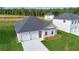 Newly built single-story home with a spacious front yard and a two-car garage at 246 Orwell Dr, Social Circle, GA 30025