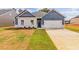Charming single-story home featuring blue and white exterior, landscaped yard, and a two-car garage at 246 Orwell Dr, Social Circle, GA 30025