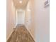 Long hallway with wood-look flooring, white walls, and recessed lighting leading toward the front entrance at 246 Orwell Dr, Social Circle, GA 30025
