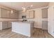 Modern kitchen featuring gray cabinets, granite countertops, stainless steel appliances, and a large island at 246 Orwell Dr, Social Circle, GA 30025