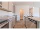 Modern kitchen featuring stainless steel appliances, granite countertops, and sleek gray cabinetry and a pantry at 246 Orwell Dr, Social Circle, GA 30025