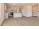 Open-concept kitchen and dining area with modern appliances, gray cabinetry, island, and wood-look flooring at 246 Orwell Dr, Social Circle, GA 30025