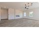 Open-concept living room featuring wood-look flooring, a modern fireplace, recessed lighting, and large windows at 246 Orwell Dr, Social Circle, GA 30025