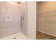 Modern bathroom with large shower, neutral colored tile, and a built-in bench at 246 Orwell Dr, Social Circle, GA 30025