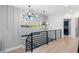 Upstairs landing with black railings, modern lighting fixtures, and view to the laundry room at 3206 Osborne Ne Rd, Brookhaven, GA 30319