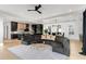 Open-concept living room featuring a modern kitchen, and a stylish gray curved sofa at 3206 Osborne Ne Rd, Brookhaven, GA 30319