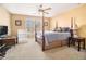 Spacious bedroom features a four-poster bed, ceiling fan, large windows, and carpeted floors at 3901 Cherry Ridge Blvd, Decatur, GA 30034