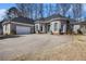 Attractive home featuring a spacious driveway, a two-car garage, and classic architectural details at 3901 Cherry Ridge Blvd, Decatur, GA 30034
