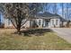 Charming brick home with a well-maintained lawn and blossoming tree in a suburban neighborhood at 3901 Cherry Ridge Blvd, Decatur, GA 30034