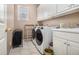 The laundry room includes a washer, dryer, utility sink, storage cabinets and a window at 3901 Cherry Ridge Blvd, Decatur, GA 30034