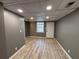 Basement featuring gray walls, vinyl floor, white trim, and a window at 705 Bridge Se Ln, Smyrna, GA 30082