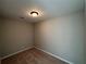 Neutral bedroom has a carpeted floor and simple lighting fixture at 705 Bridge Se Ln, Smyrna, GA 30082