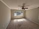 Spacious bedroom with a ceiling fan, window, and neutral color scheme at 705 Bridge Se Ln, Smyrna, GA 30082