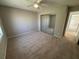 Carpeted bedroom with mirrored closet doors and a ceiling fan at 705 Bridge Se Ln, Smyrna, GA 30082