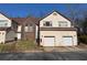 Lovely townhome featuring a well-kept front lawn, brick accents, and two-car garage at 705 Bridge Se Ln, Smyrna, GA 30082