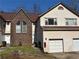 Charming townhome featuring a brick facade, attached garage, and well-maintained landscaping at 705 Bridge Se Ln, Smyrna, GA 30082