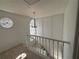 Bright hallway features a decorative window, a light fixture, and a staircase with white railing at 705 Bridge Se Ln, Smyrna, GA 30082