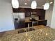 Well-lit kitchen featuring stainless steel appliances, dark wood cabinetry, and a spacious granite island at 705 Bridge Se Ln, Smyrna, GA 30082