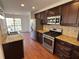Modern kitchen with stainless appliances, granite countertops, and dark wood cabinets at 705 Bridge Se Ln, Smyrna, GA 30082