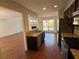 Open kitchen with stainless appliances, granite countertops, and views into the dining and living rooms at 705 Bridge Se Ln, Smyrna, GA 30082