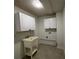 Laundry room with tile floors, cabinets and sink at 705 Bridge Se Ln, Smyrna, GA 30082